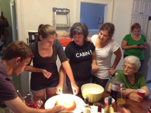 My cousin Duncan, sister Genevieve and mother Helena lighting my birthday cake