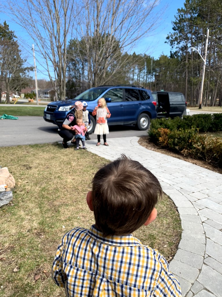 Arthur staring at our friends, who are at the end of our walkway during a socially distanced visit.
